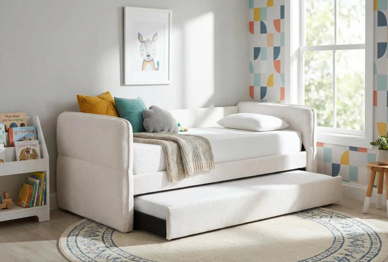 White sofa bed in a room with books and a rug
