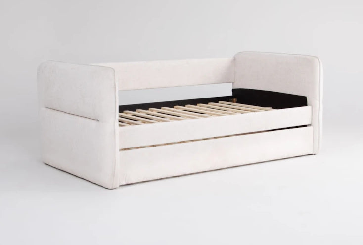 White upholstered bed with wooden slats on a light gray background