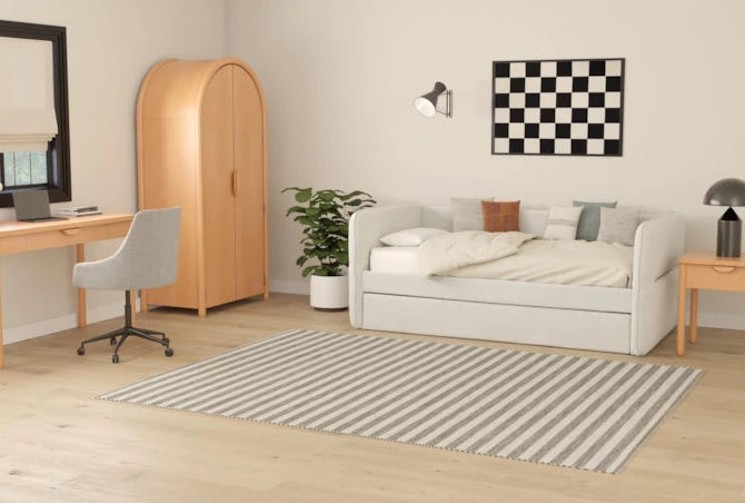 Modern bedroom with a bed, desk, wardrobe, and decor items.