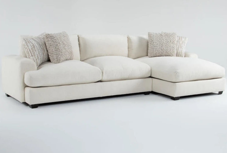 White sectional sofa with textured cushions on a light gray background
