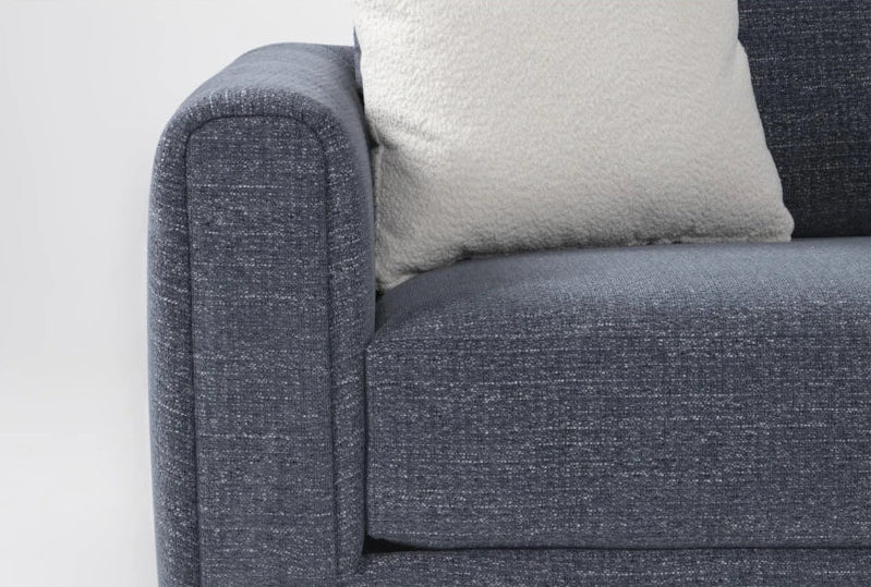 Sofa with a textured surface and a cushion on a white background