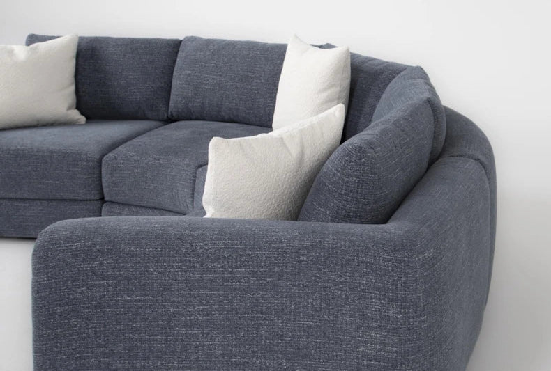 Sectional sofa with white cushions on a white background