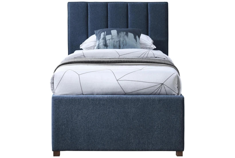 Blue upholstered bed with a geometric-patterned mattress on a white background