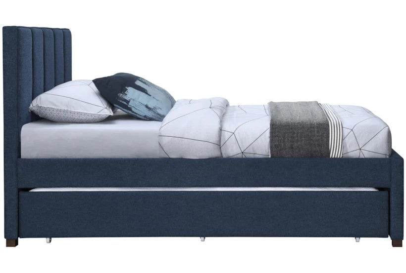 Blue upholstered bed with white bedding and decorative pillows on a white background