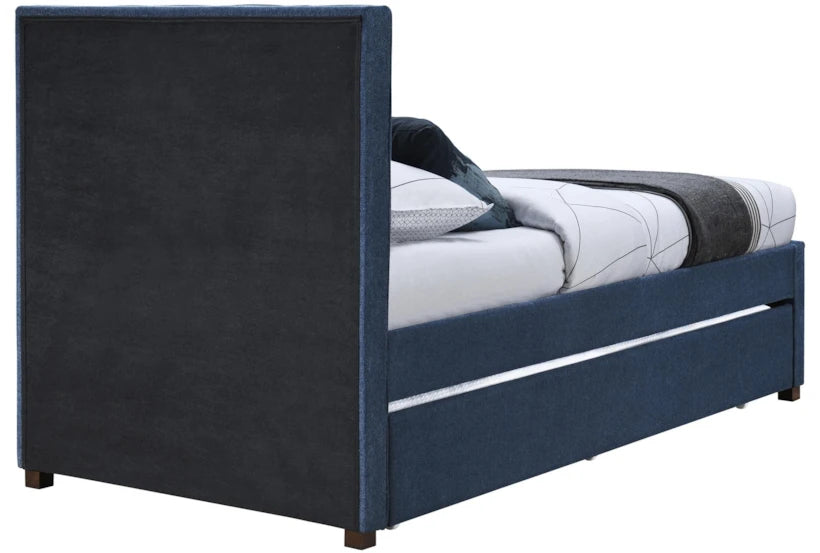 Blue upholstered bed with white bedding on a white background