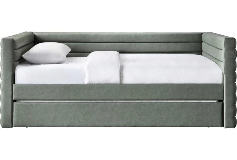Gray upholstered bed with white bedding on a white background