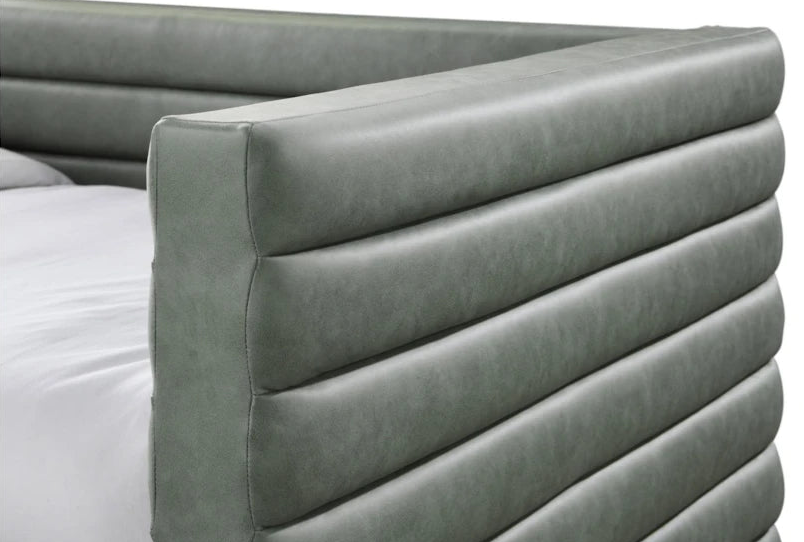 Gray upholstered headboard on a bed