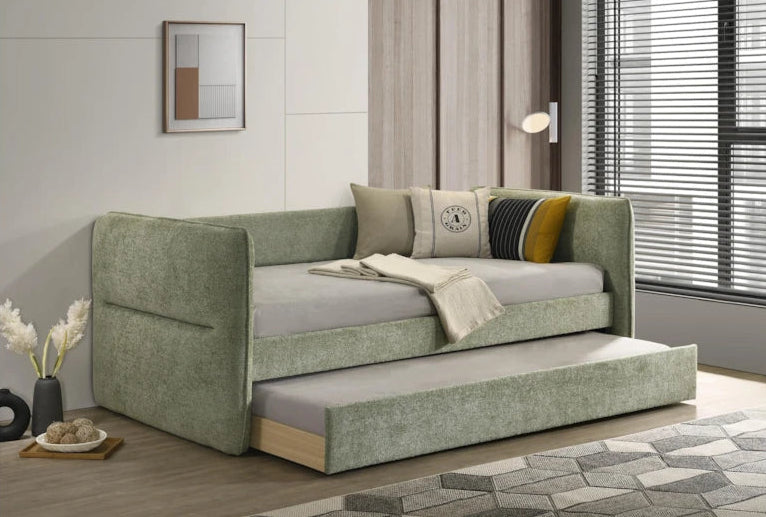 Green sofa bed with pull-out bed in a room with a window and decor.