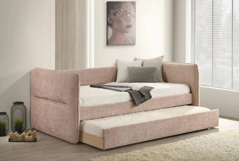 Pink sofa bed with white mattress in a room with light-colored walls and decor.