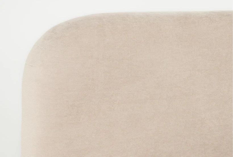 Close-up of a beige textured ottoman on a white background
