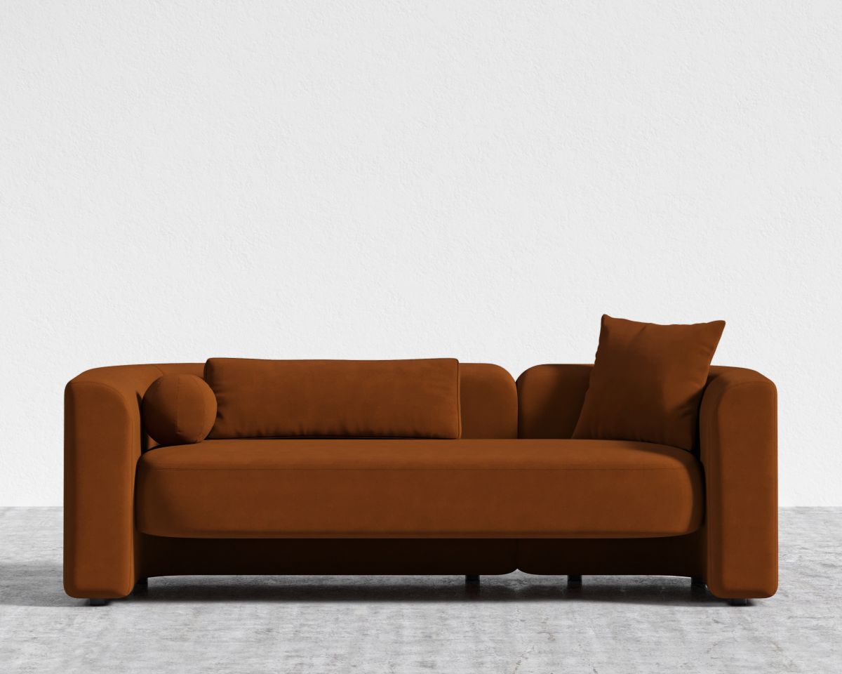 Brown sofa with two cushions on a light gray floor and white background