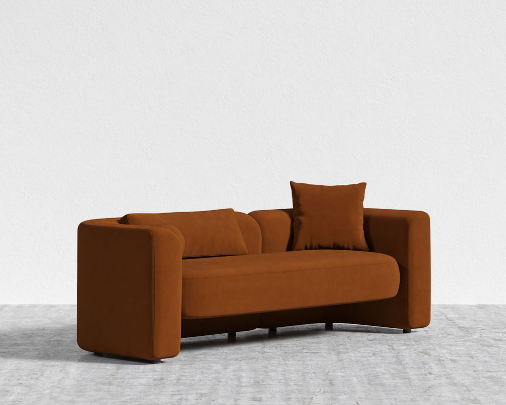 Brown sofa with two cushions on a light gray floor and white background