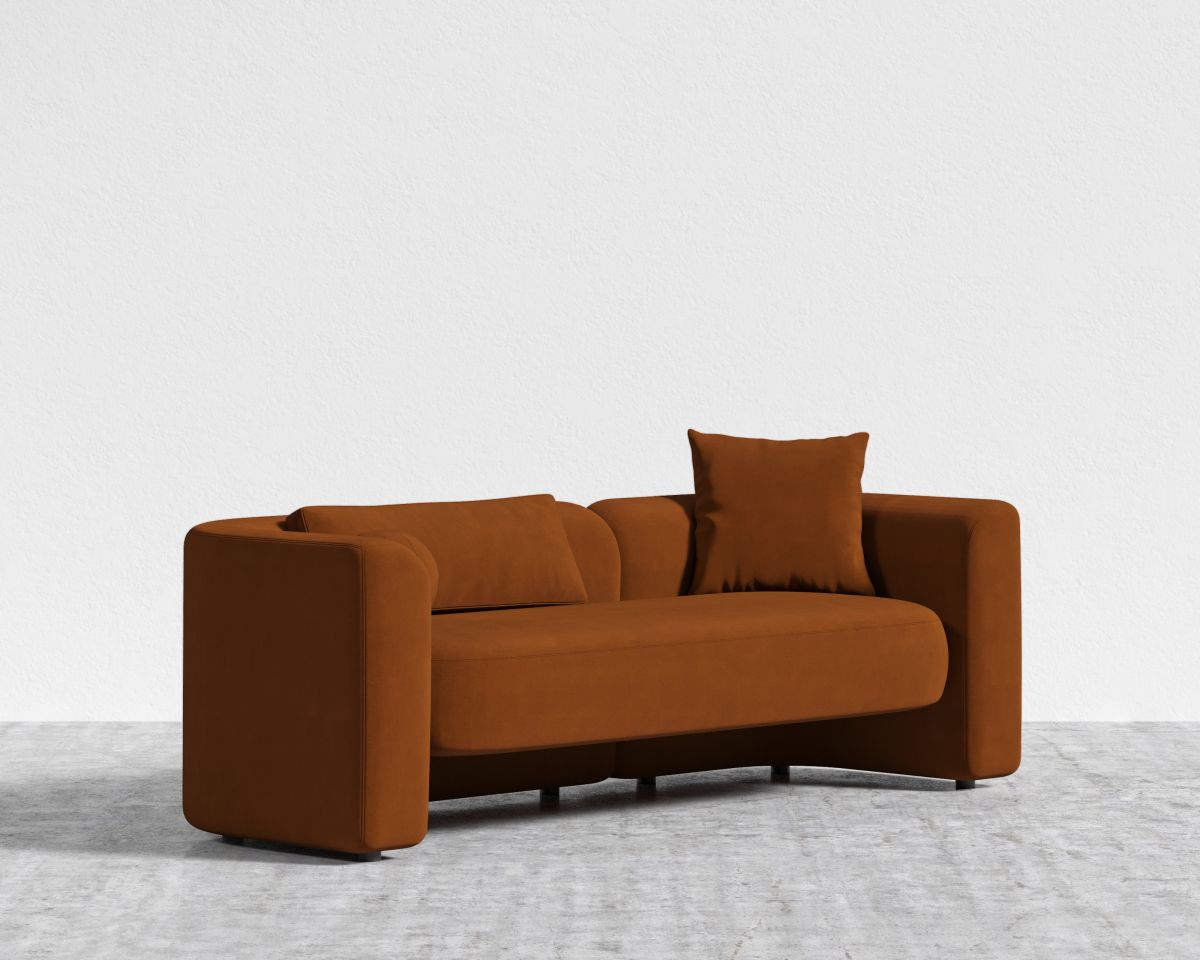 Brown sofa with two cushions on a light gray floor and white background