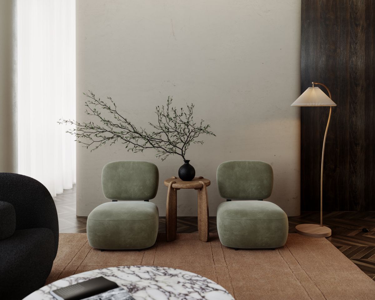 Modern living room with two green chairs, a small table with a vase, and a floor lamp.