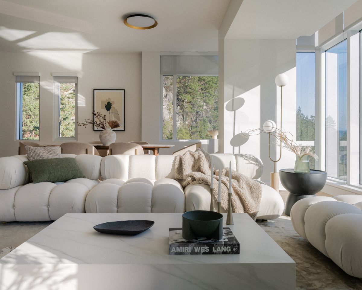 Modern living room with white furniture and large windows