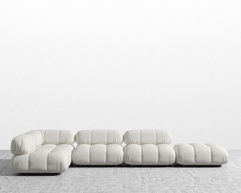 Modern white sofa on a textured floor with a light gray background