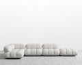 Modern white sofa on a textured floor with a light gray background