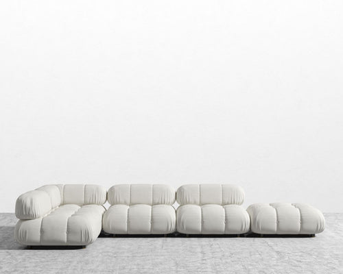 Modern white sofa on a textured floor with a light gray background
