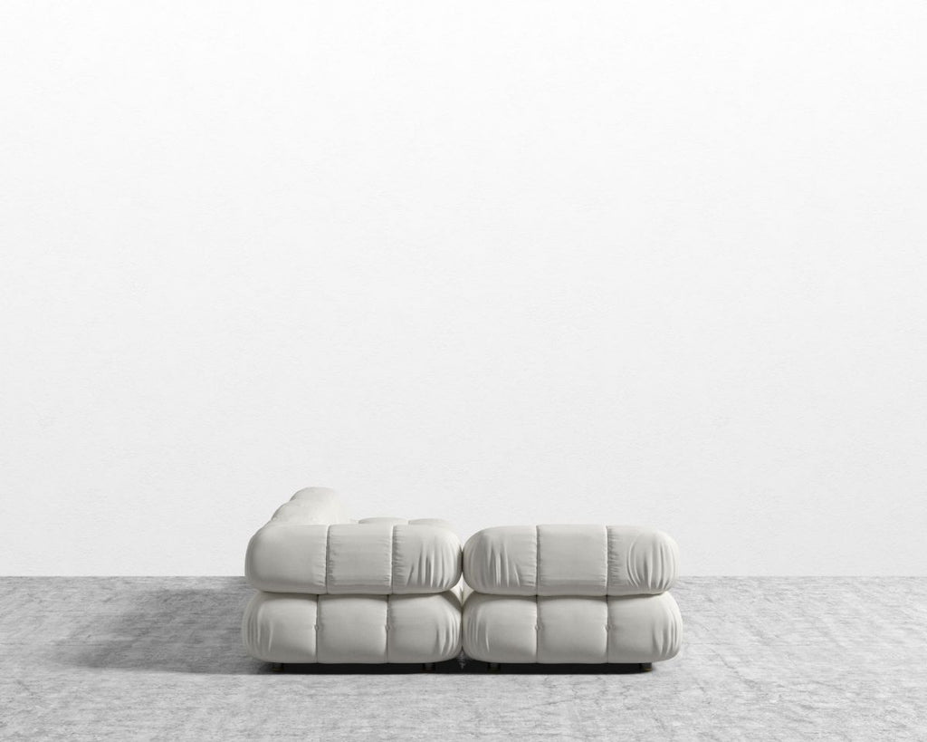 White sofa on a light gray surface with a white background