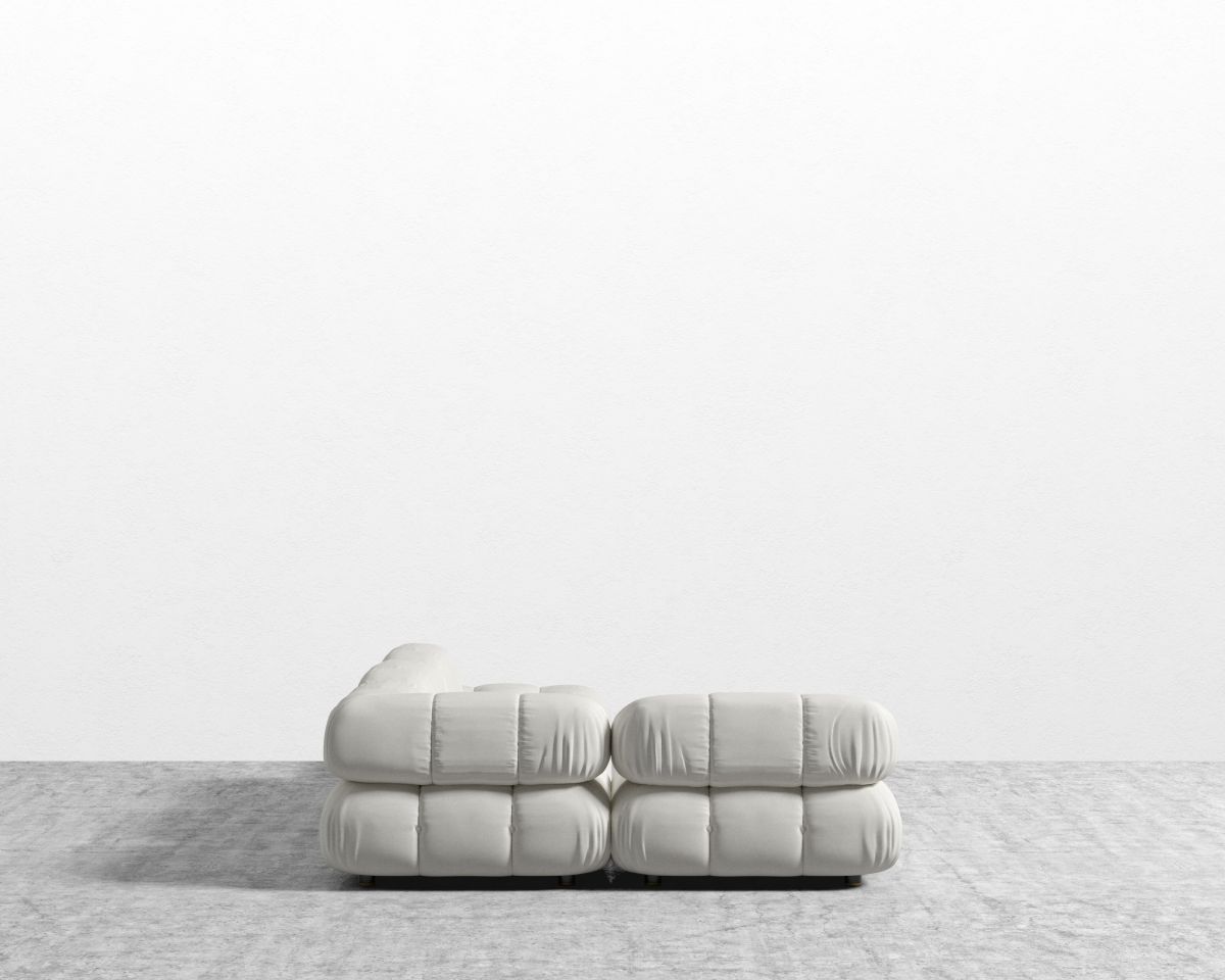 White sofa on a light gray surface with a white background