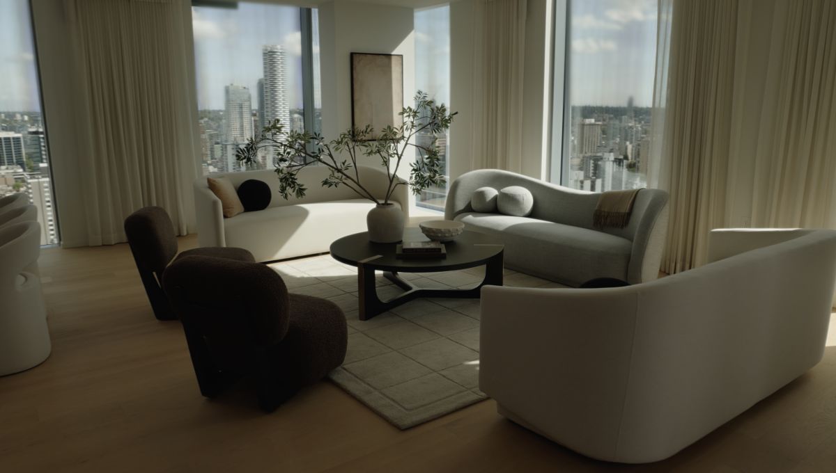 Modern living room with white furniture and large windows overlooking a cityscape.